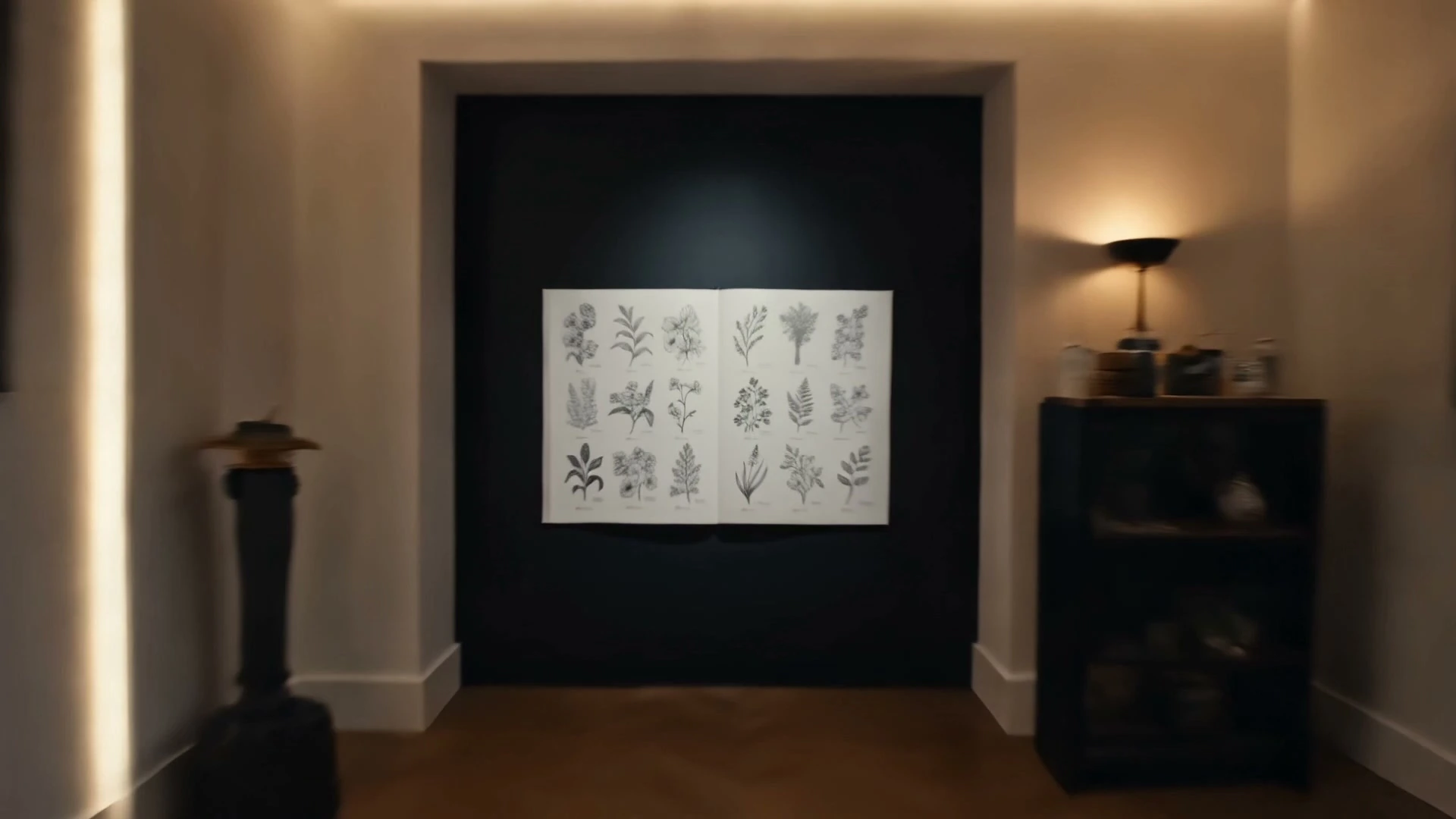 The front alcove at Blackbird, a framed botanical illustration plate lit by a brass sconce